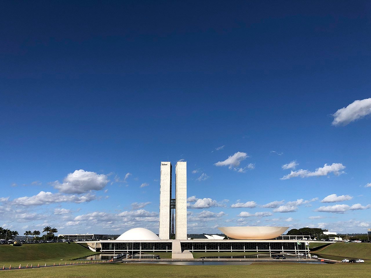 Fachada do Congresso Nacional em Brasília vista do gramado, com as duas torres e as cúpulas
