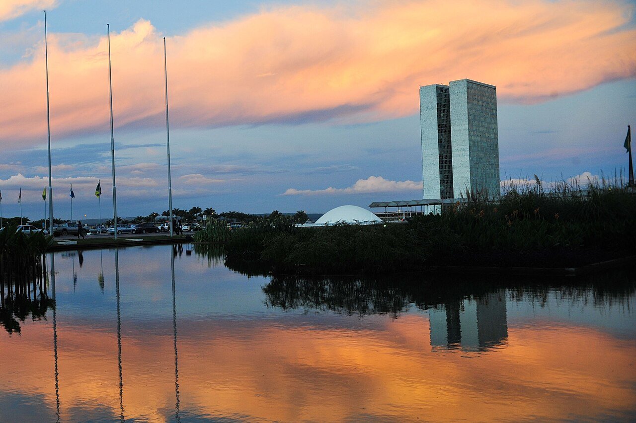 Congresso Nacional ao entardecer, em Brasília, refletido no espelho d'água
