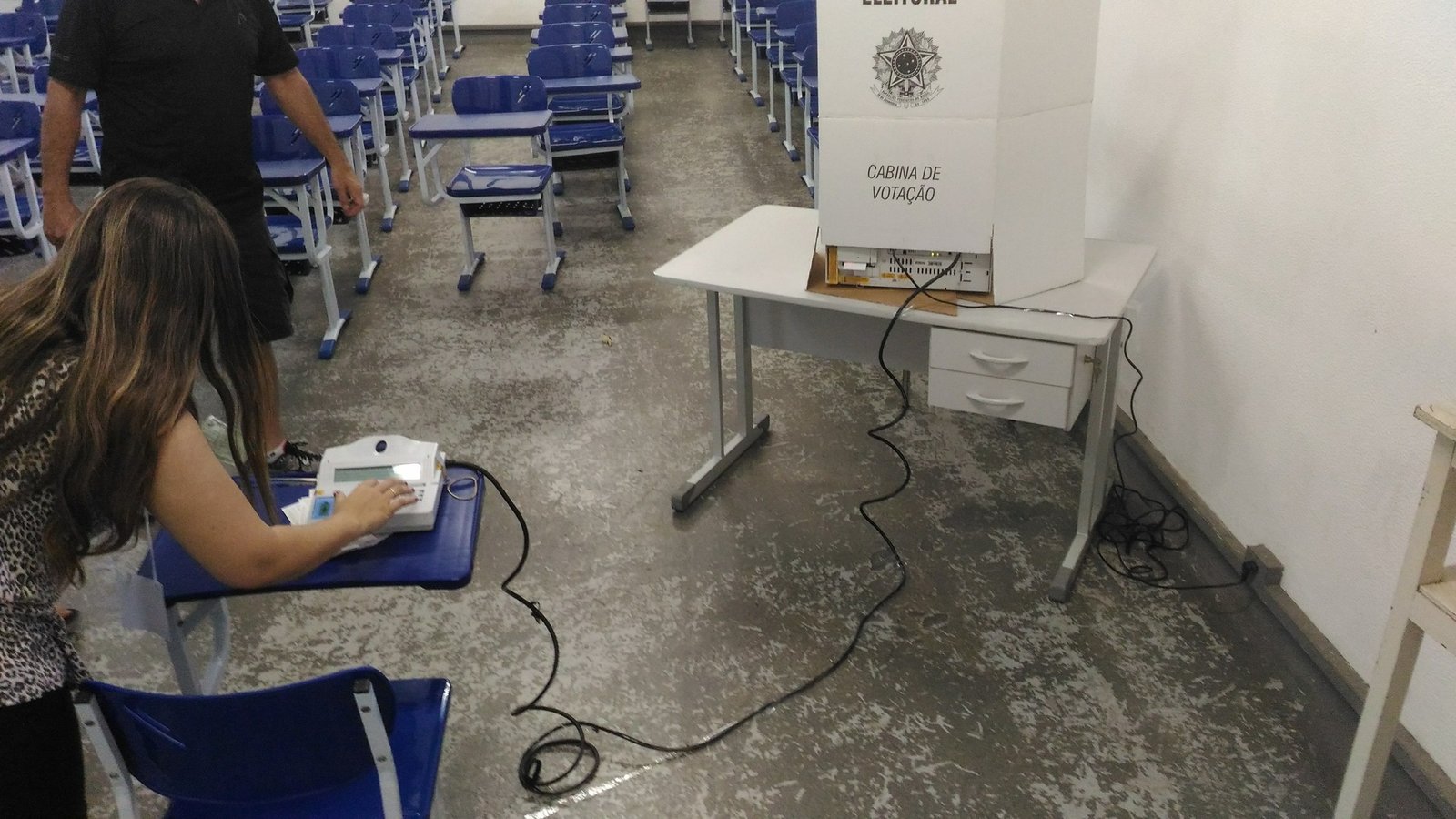 Mesária usa o terminal do mesário para liberar uma urna eletrônica em sala de aula, foto de arquivo de 2016